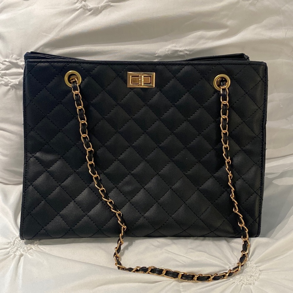 Black quilted shoulder bag with gold chain.
